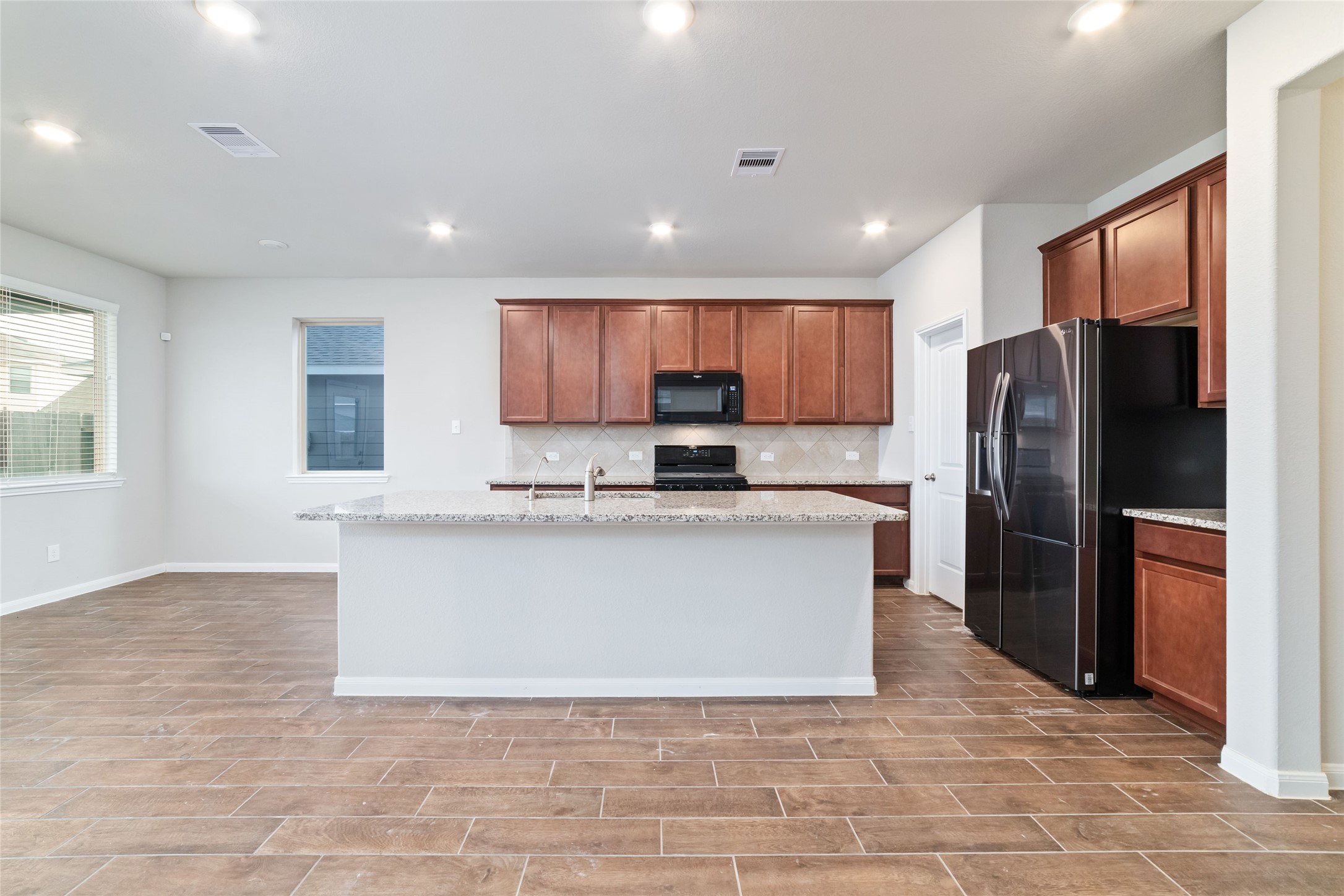 21622 Buttonsage Lane Katy, TX 77449 - Photo 8 of 17 a large kitchen with stainless steel appliances granite countertop a refrigerator a stove a sink and a microwave