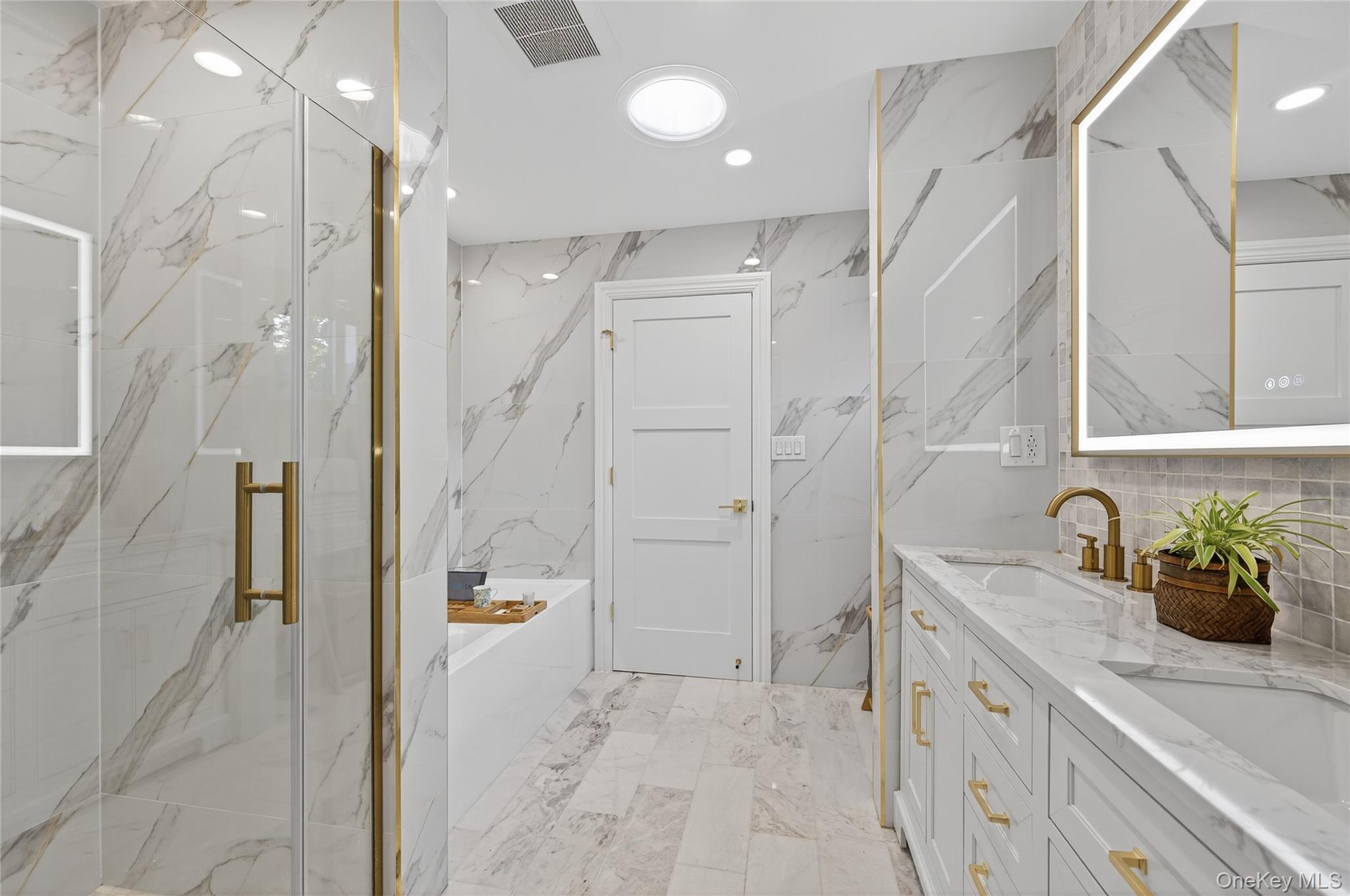80 Clapham Avenue Manhasset, NY 11030 - Photo 23 of 31 Full bath with stone wall, a bath, double vanity, recessed lighting, and a marble finish shower