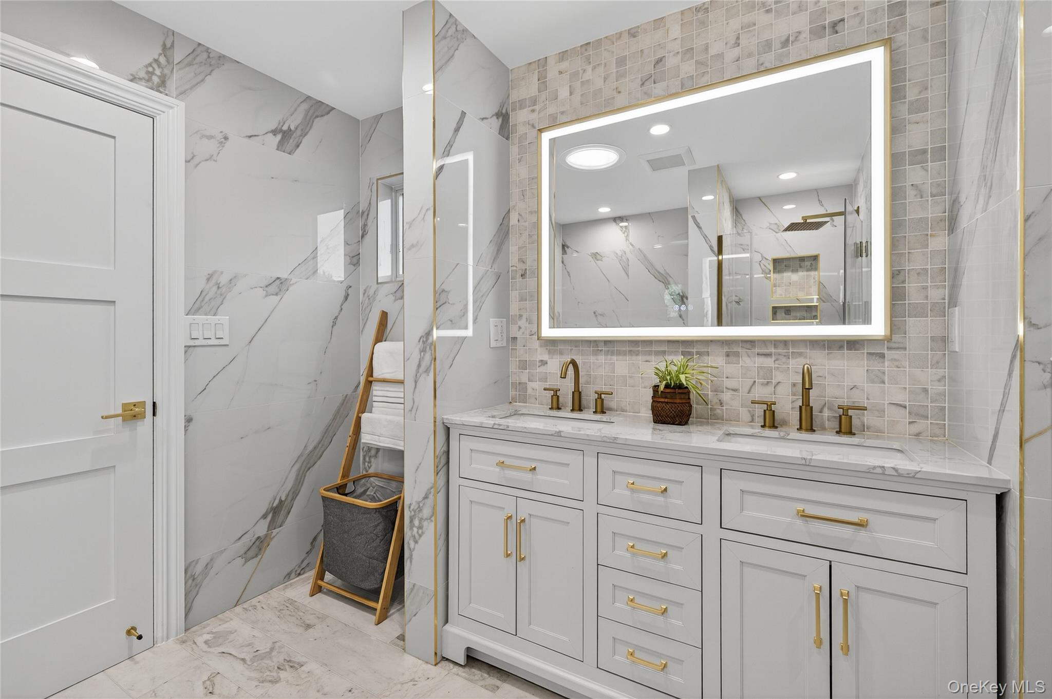 80 Clapham Avenue Manhasset, NY 11030 - Photo 24 of 31 Full bathroom featuring tile walls, double vanity, a marble finish shower, backsplash, and recessed lighting