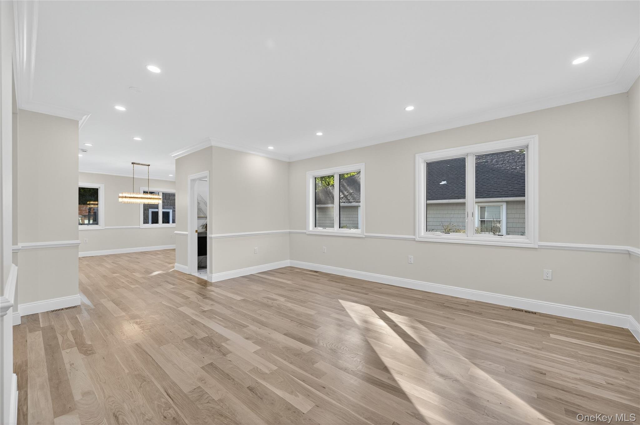 80 Clapham Avenue Manhasset, NY 11030 - Photo 4 of 31 Unfurnished living room featuring light wood-style flooring, recessed lighting, and ornamental molding