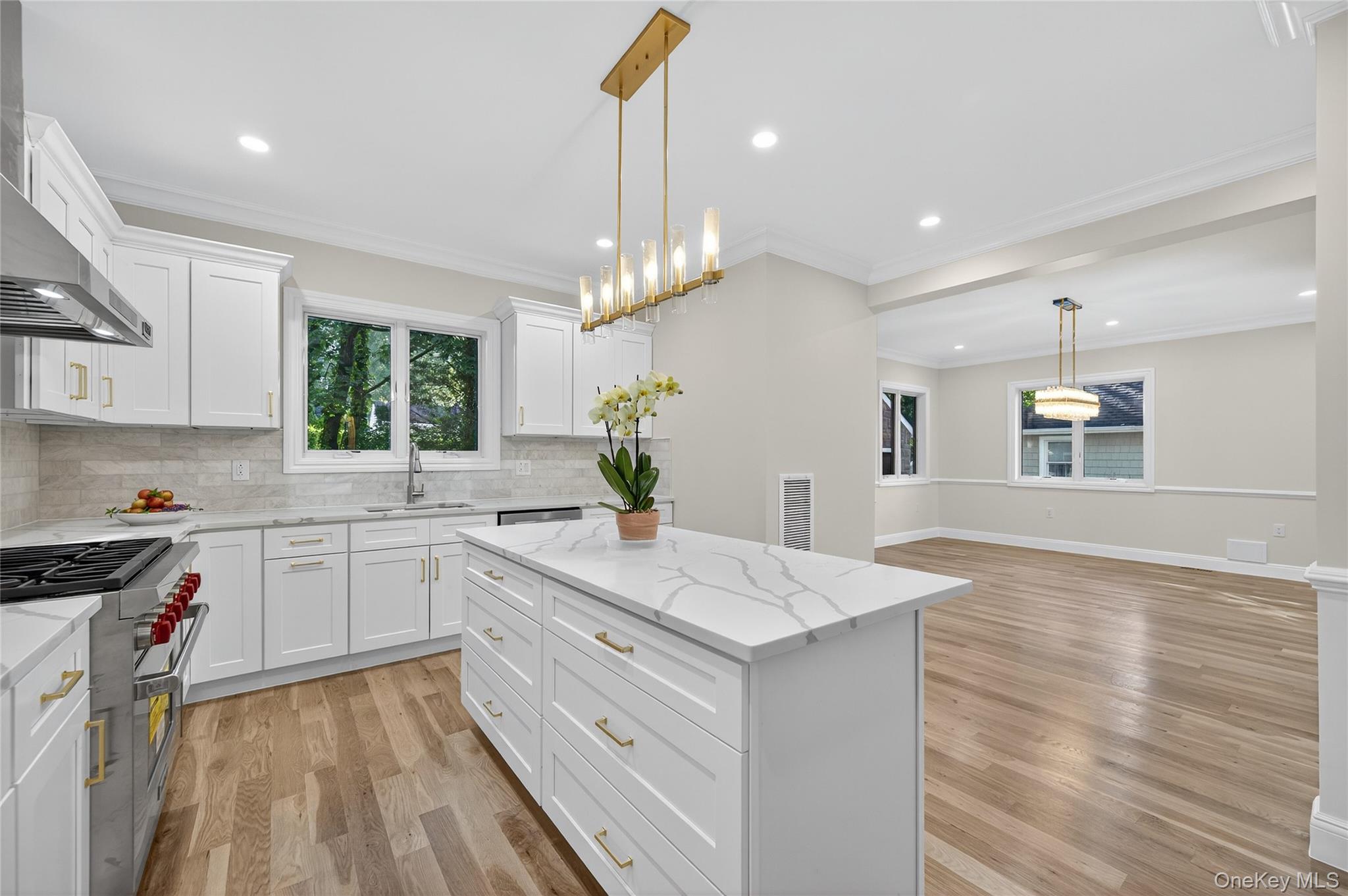 80 Clapham Avenue Manhasset, NY 11030 - Photo 9 of 31 Kitchen featuring designer stove, pendant lighting, ornamental molding, a center island, and backsplash