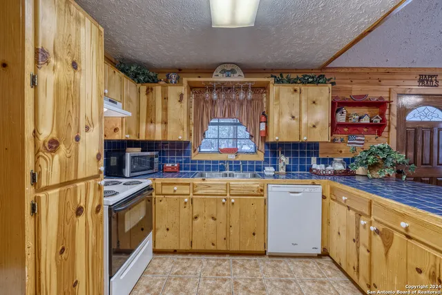 a kitchen with a stove and cabinets
