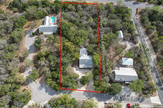 an aerial view of a house with a yard and garden