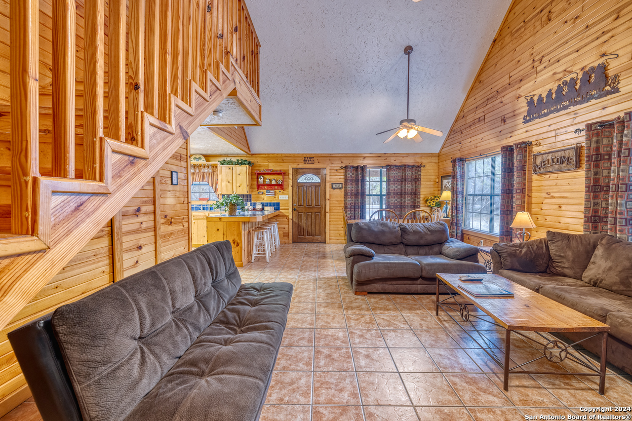 65 Comanche Crk Road Concan, TX 78838 - Photo 3 of 24 a living room with furniture a wooden floor and next to a window