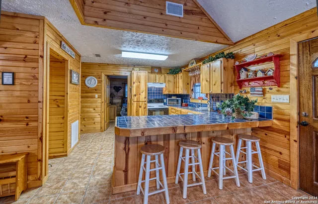a view of a kitchen with a table and chairs in it