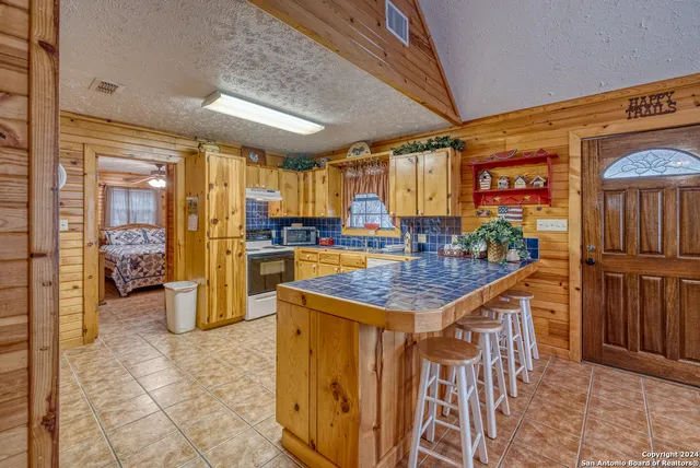 a kitchen with stainless steel appliances granite countertop a stove refrigerator and cabinets