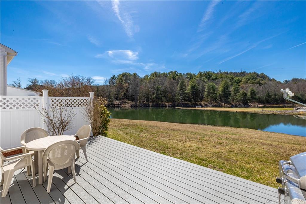 a view of a lake with table and chairs