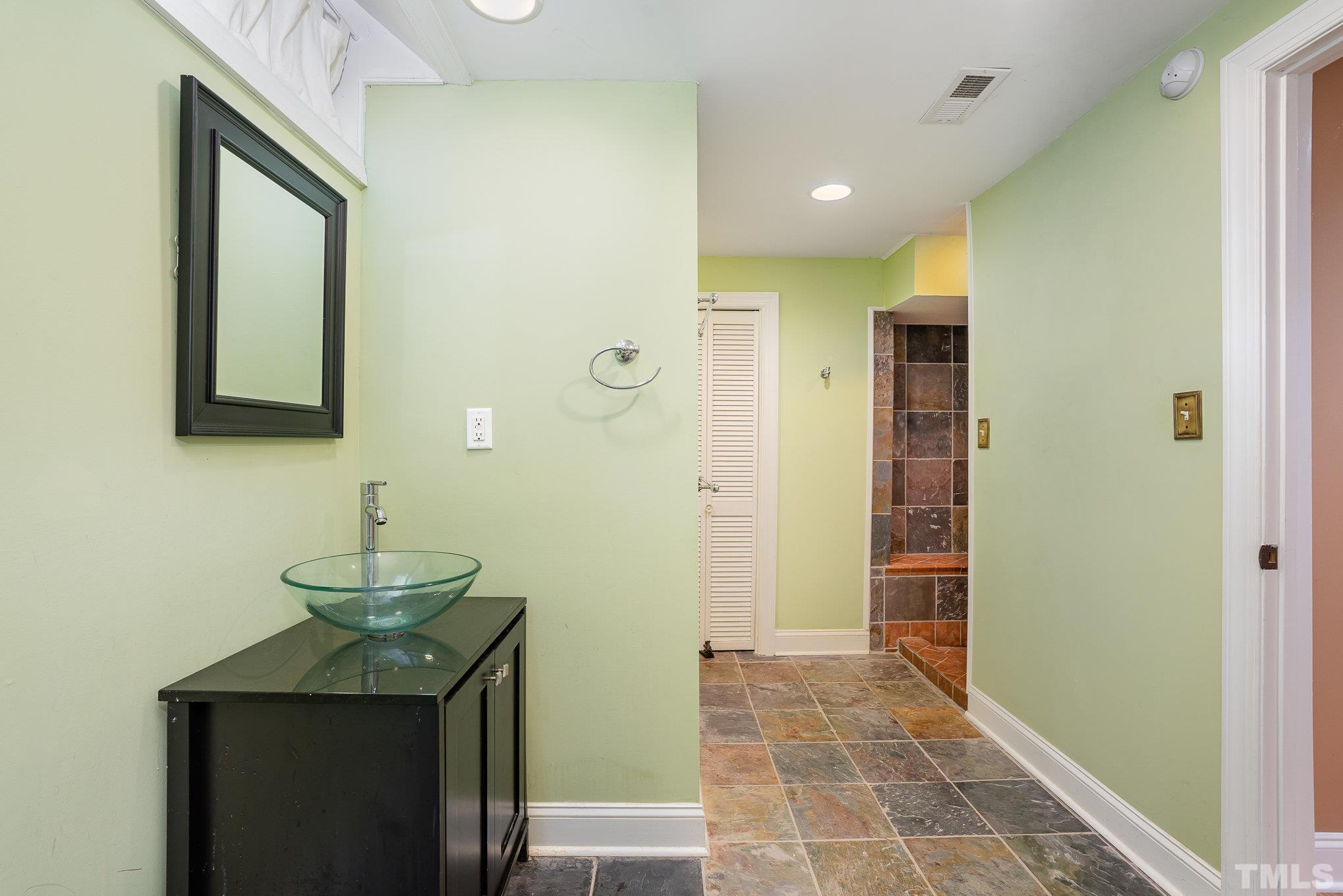 9300 Palm Bay Circle Raleigh, NC 27617 - Photo 14 of 30 a bathroom with a sink and a mirror
