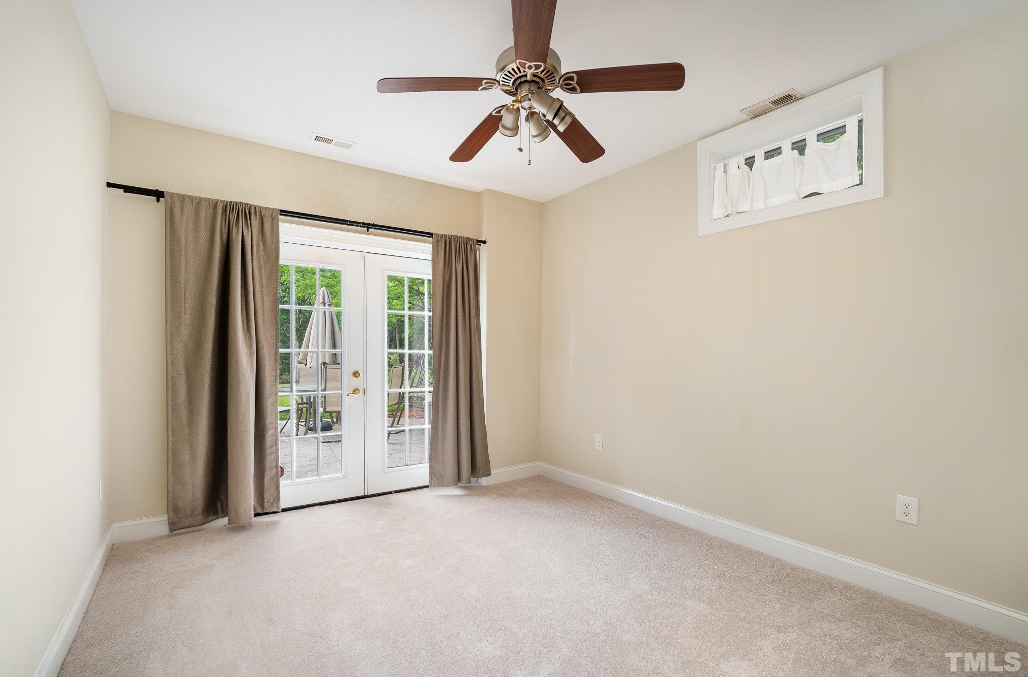 9300 Palm Bay Circle Raleigh, NC 27617 - Photo 15 of 30 an empty room with windows and fan