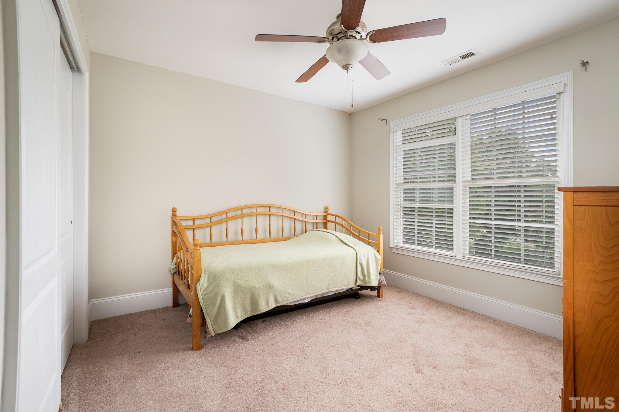9300 Palm Bay Circle Raleigh, NC 27617 - Photo 18 of 30 a spacious bedroom with a bed and a large window