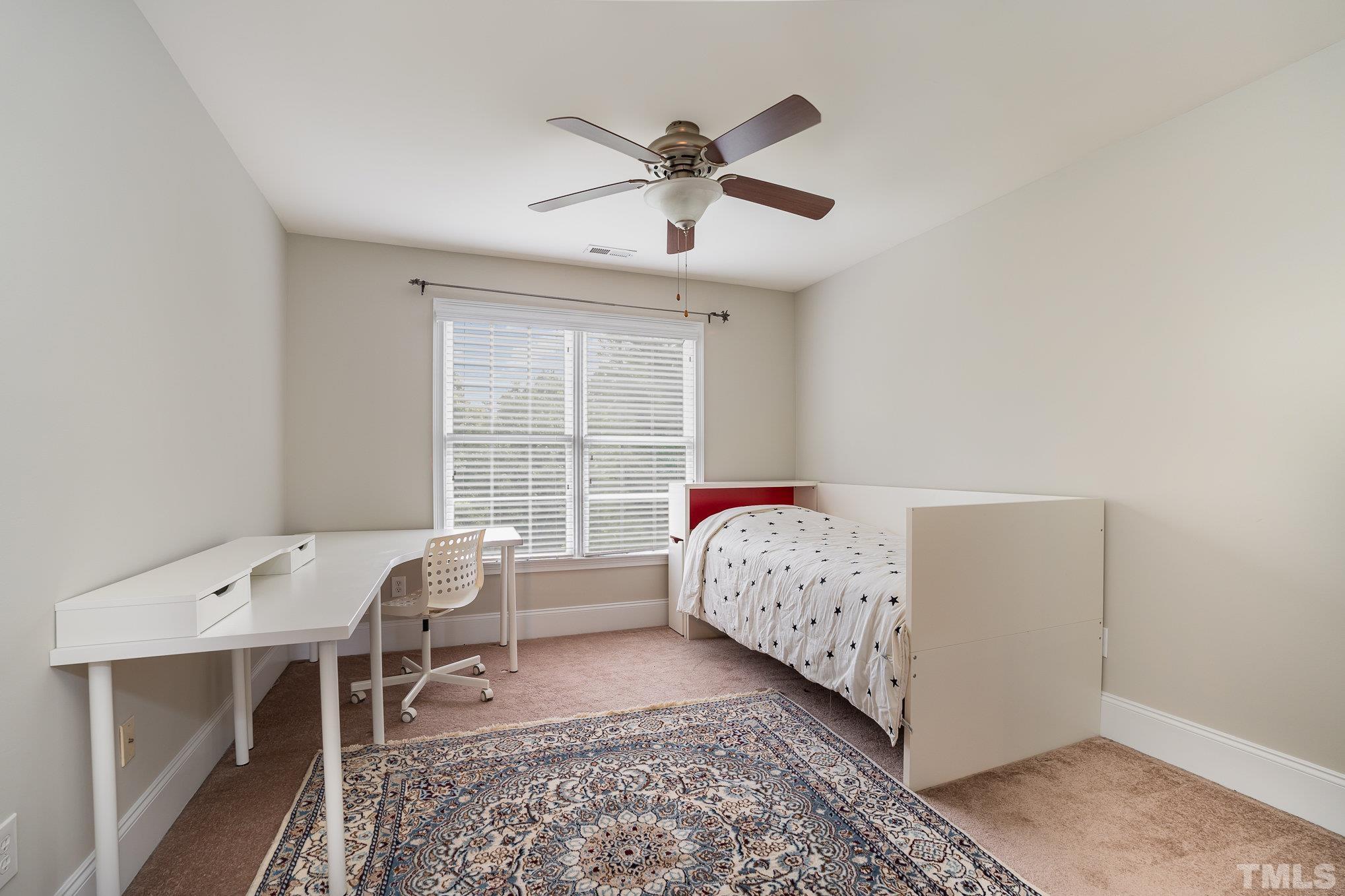 9300 Palm Bay Circle Raleigh, NC 27617 - Photo 19 of 30 a bed room with a bed and a window