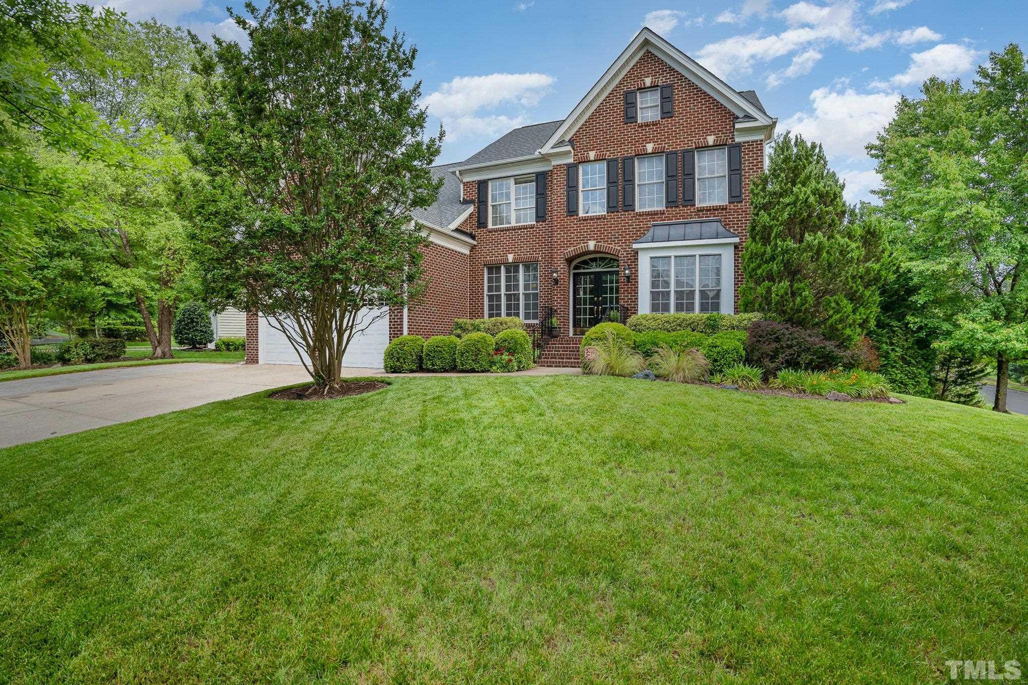 9300 Palm Bay Circle Raleigh, NC 27617 - Photo 2 of 30 a front view of a house with a yard