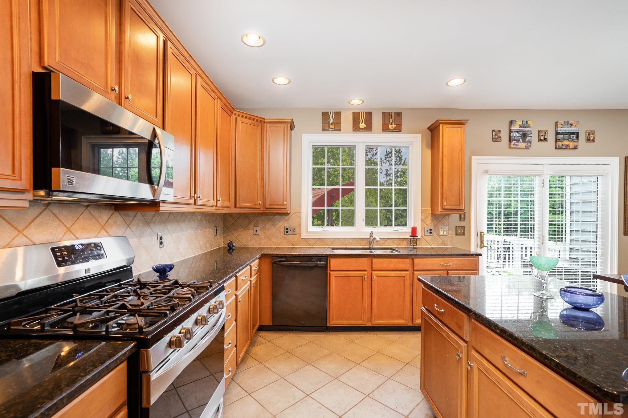 9300 Palm Bay Circle Raleigh, NC 27617 - Photo 10 of 30 a kitchen with stainless steel appliances granite countertop a stove and a sink