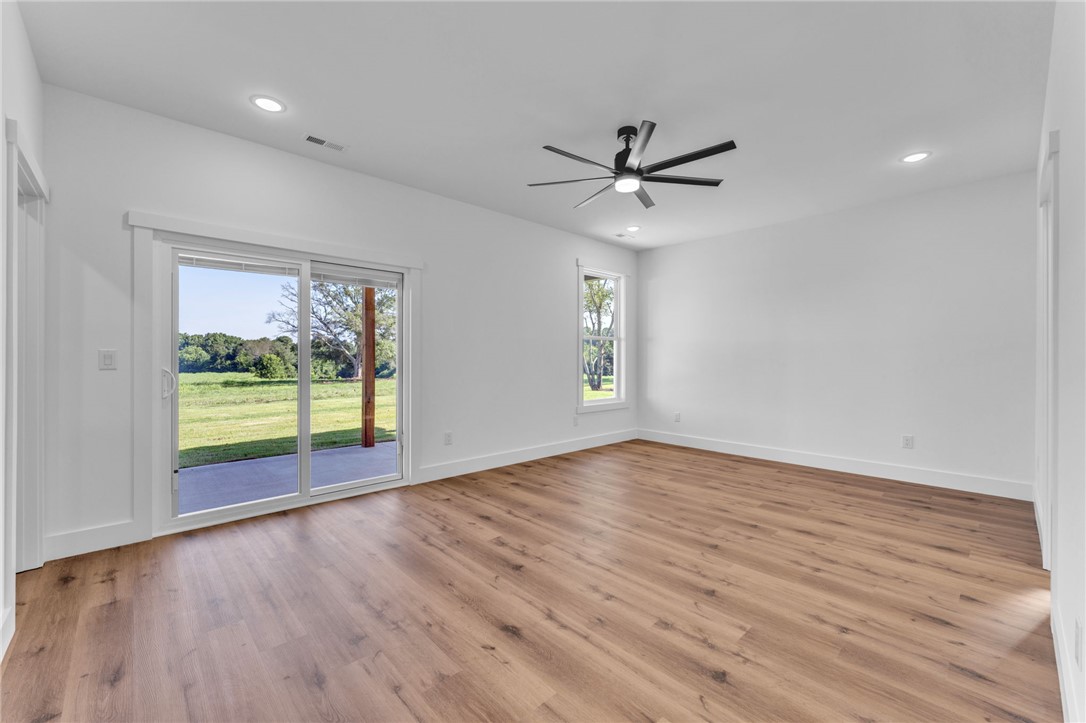 1723 Harris Bridge Road Anderson, SC 29621 - Photo 12 of 33 A spacious room offers direct access to the outdoors and wide-plank wood flooring.