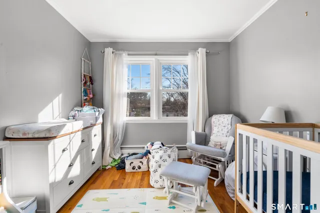 a bedroom with furniture and a wooden floor