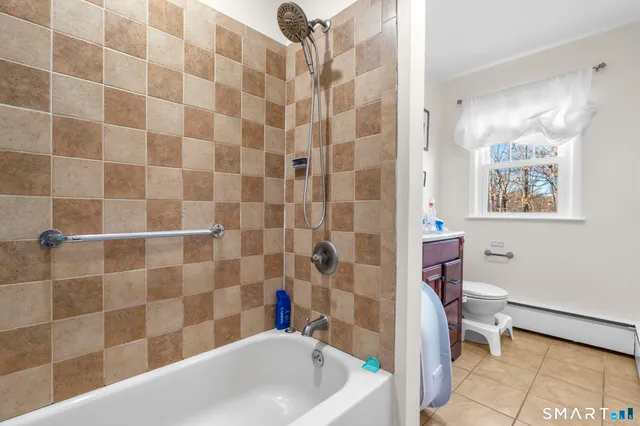 a living room with furniture a fireplace and a chandelier