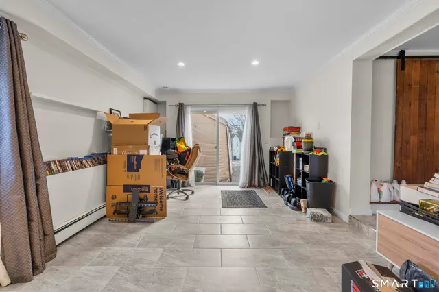 a view of a room with gym equipment and a large window