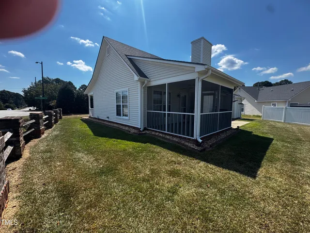 a view of a house with backyard and porch