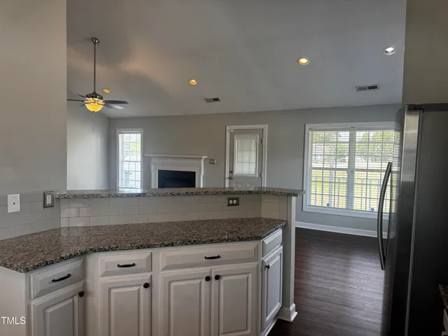 a kitchen with granite countertop a sink and a stove