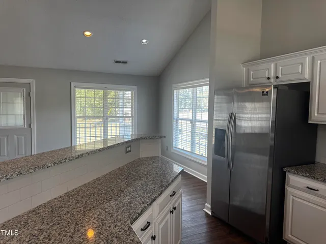 an empty room with wooden floor and a window