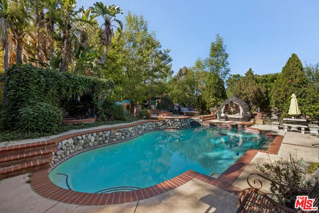 a view of a swimming pool with chairs