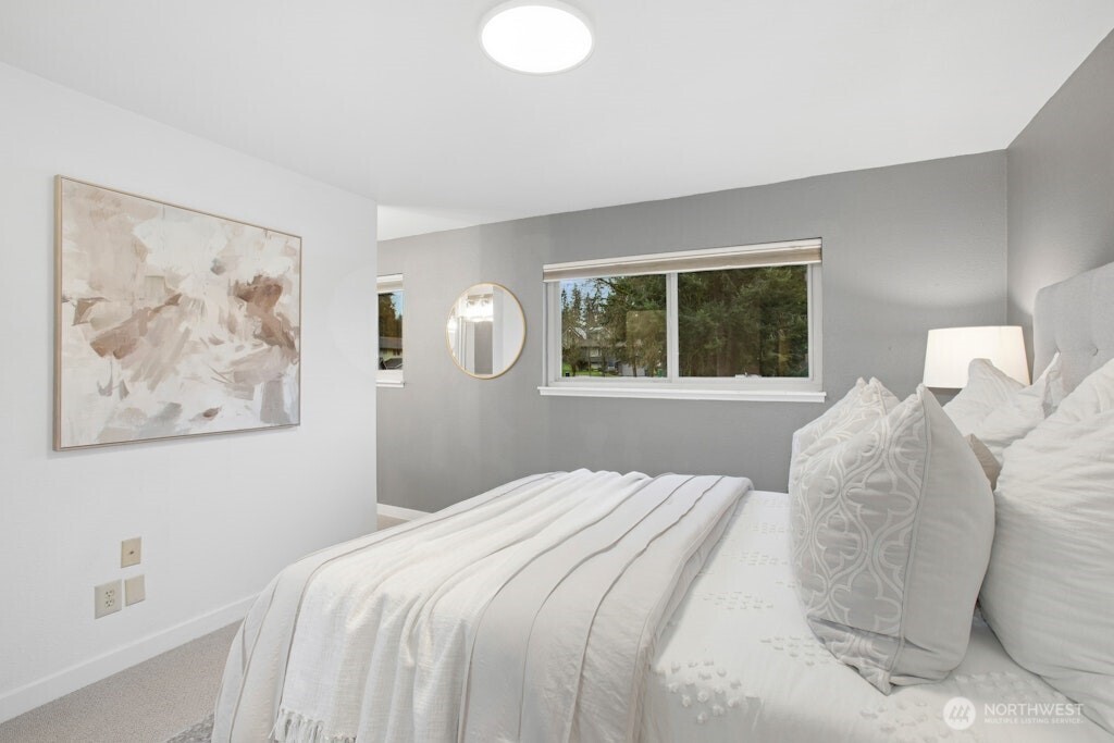 1104 204th Place Southeast Bothell, WA 98012 - Photo 14 of 30 a bedroom with a large bed and a window