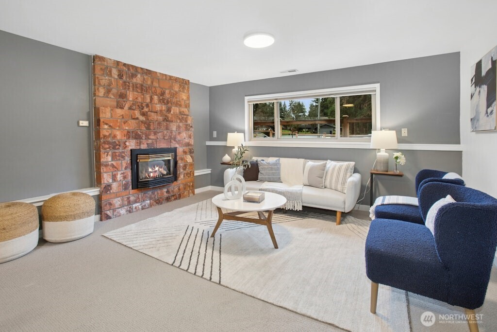 1104 204th Place Southeast Bothell, WA 98012 - Photo 20 of 30 a living room with furniture and a fireplace
