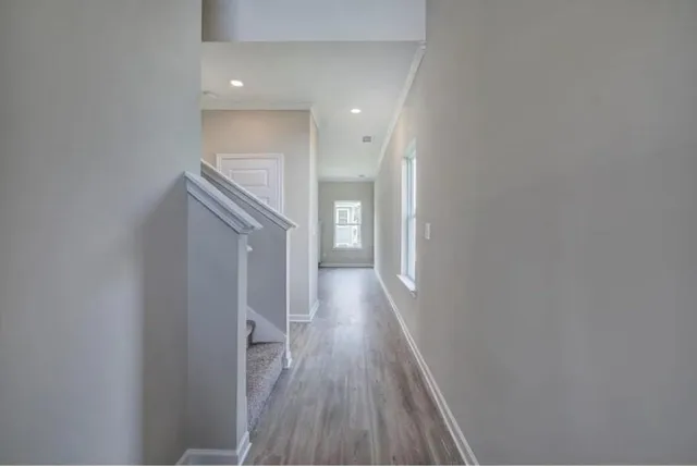 a view of hallway with wooden floor