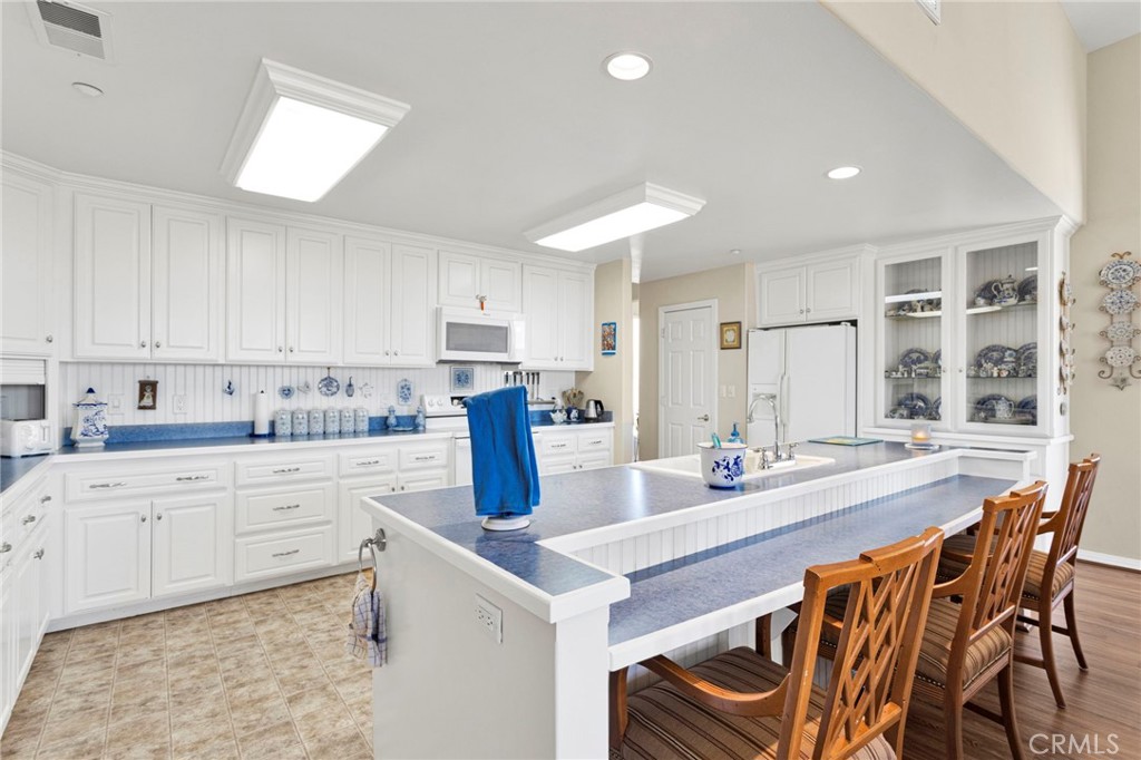 16222 Wild Road Helendale, CA 92342 - Photo 16 of 75 a kitchen with stainless steel appliances granite countertop a table chairs sink and cabinets