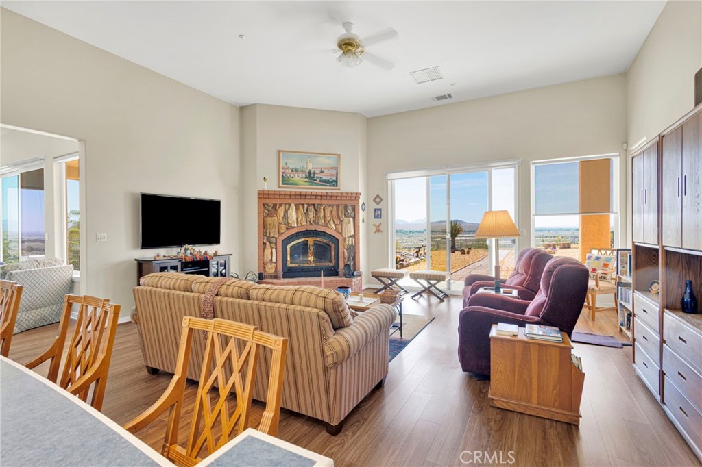 16222 Wild Road Helendale, CA 92342 - Photo 18 of 75 a living room with furniture a flat screen tv and a fireplace