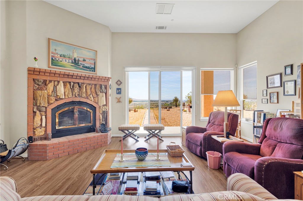 16222 Wild Road Helendale, CA 92342 - Photo 19 of 75 a living room with furniture fireplace and a table