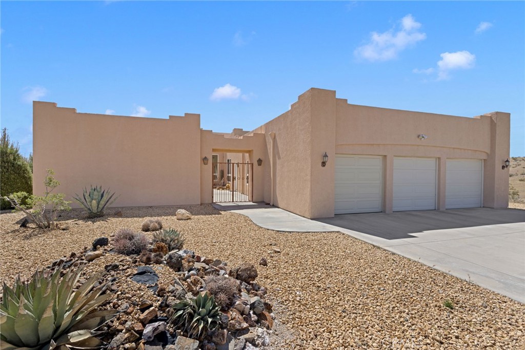 16222 Wild Road Helendale, CA 92342 - Photo 2 of 75 a view of a house with a snow on the road and a building