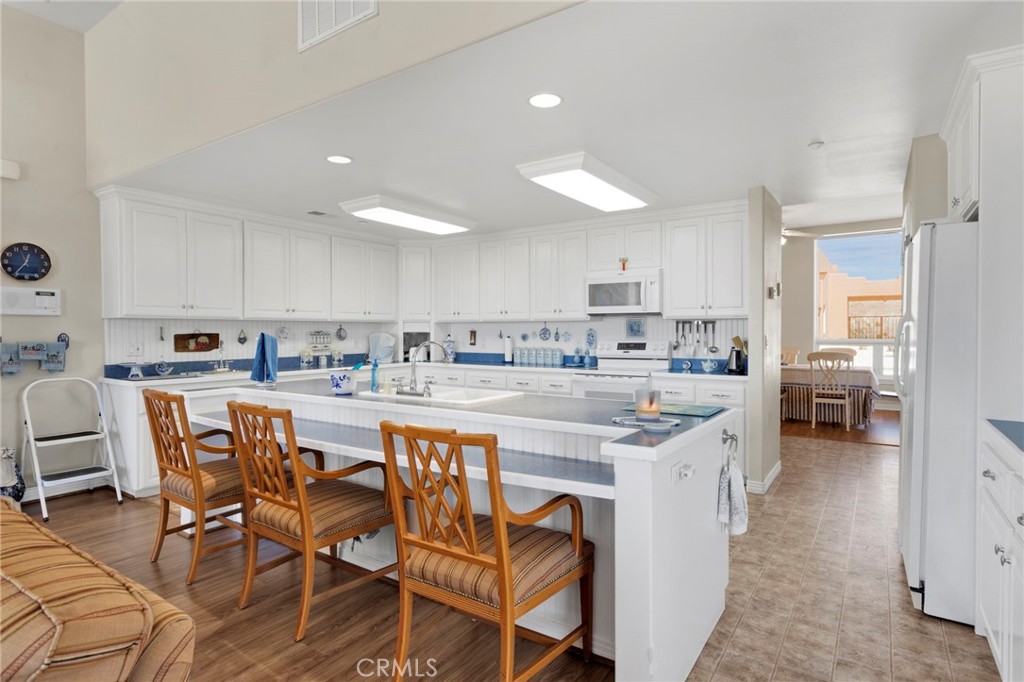 16222 Wild Road Helendale, CA 92342 - Photo 22 of 75 a kitchen with stainless steel appliances granite countertop a table and chairs in it