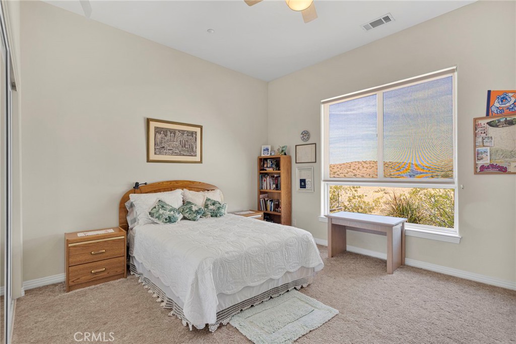16222 Wild Road Helendale, CA 92342 - Photo 27 of 75 a bedroom with a bed and a large window
