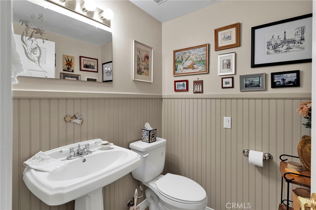 16222 Wild Road Helendale, CA 92342 - Photo 31 of 75 a bathroom with a toilet sink and mirror