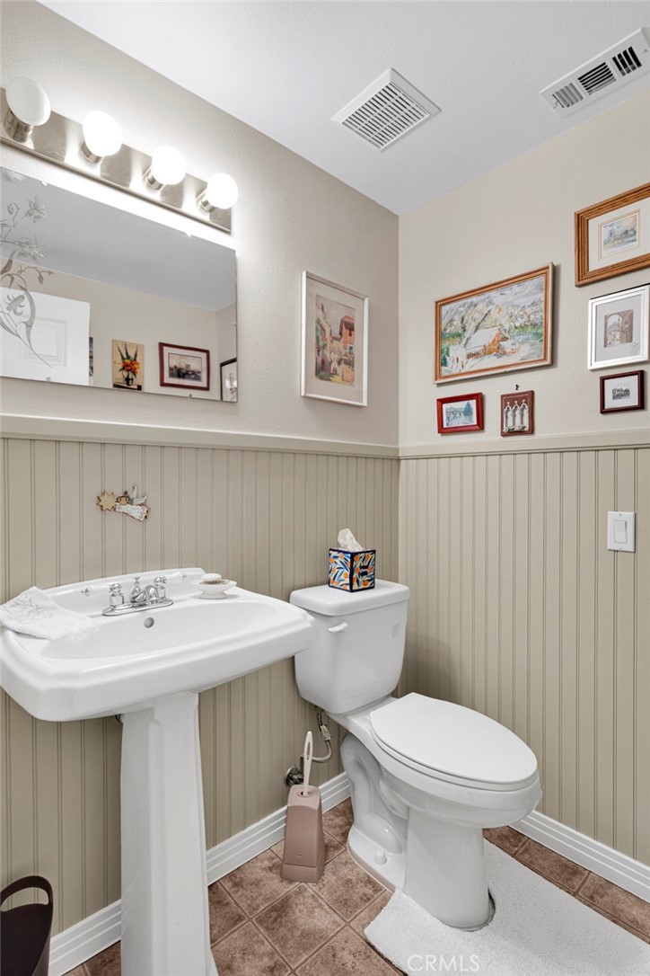 16222 Wild Road Helendale, CA 92342 - Photo 32 of 75 a bathroom with a toilet a sink and mirror