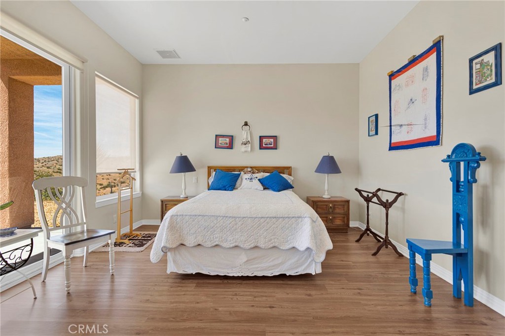 16222 Wild Road Helendale, CA 92342 - Photo 34 of 75 a spacious bedroom with a bed and a large window