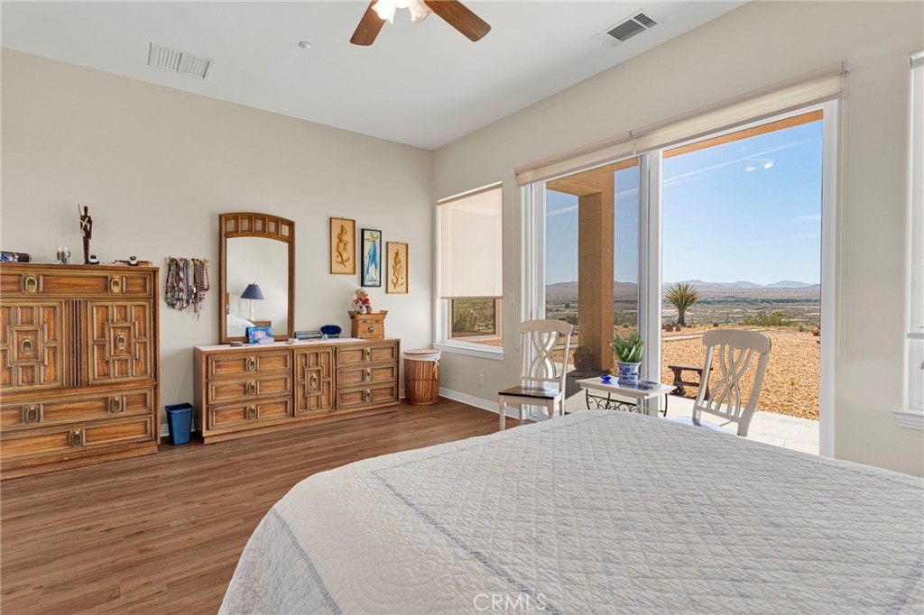 16222 Wild Road Helendale, CA 92342 - Photo 36 of 75 a spacious bedroom with a large bed and a large window