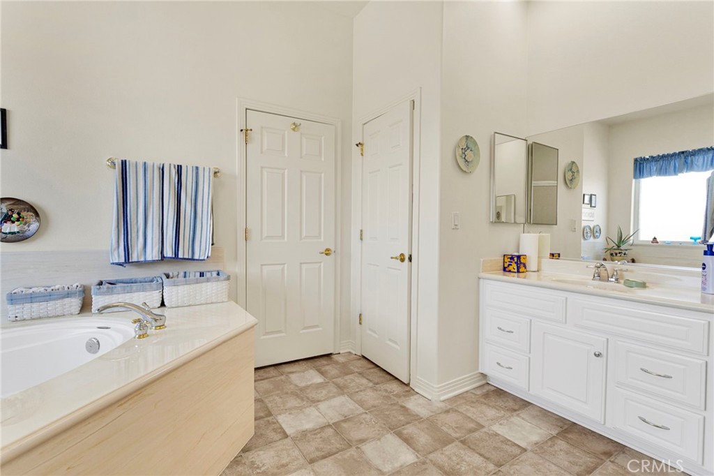 16222 Wild Road Helendale, CA 92342 - Photo 39 of 75 a bathroom with a double vanity sink mirror and bathtub