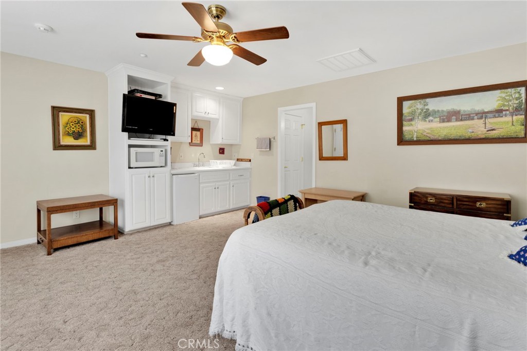 16222 Wild Road Helendale, CA 92342 - Photo 45 of 75 a bedroom with a bed and a flat screen tv