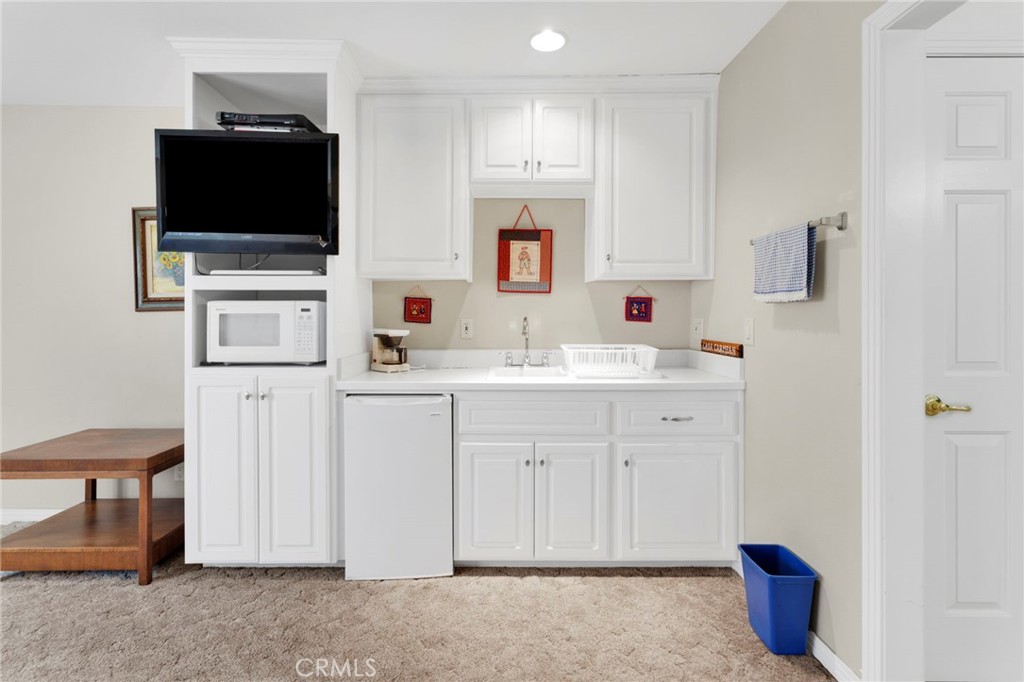 16222 Wild Road Helendale, CA 92342 - Photo 46 of 75 a kitchen with stainless steel appliances a refrigerator sink and white cabinets