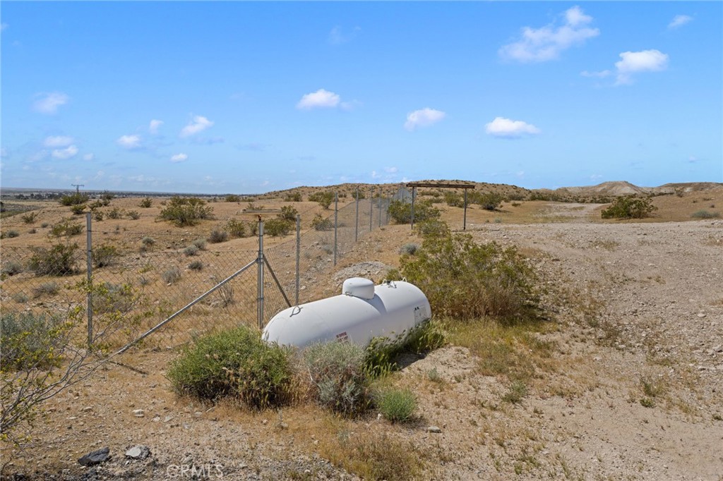 16222 Wild Road Helendale, CA 92342 - Photo 60 of 75 a view of a dry yard with an outdoor space and seating
