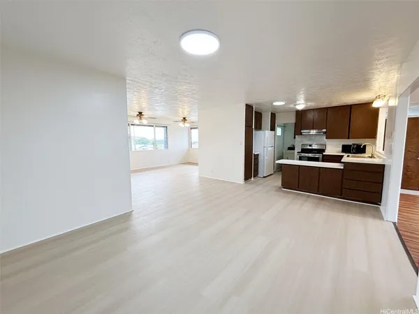 a kitchen with stainless steel appliances a refrigerator and a microwave