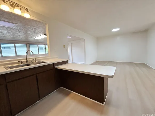a kitchen with a sink and a window