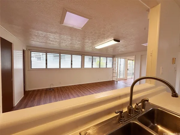 a view of a room with wooden floor