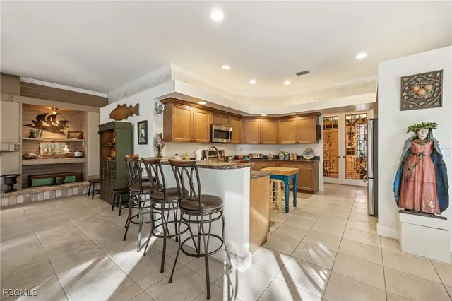 a kitchen with stainless steel appliances granite countertop a stove a sink and a microwave