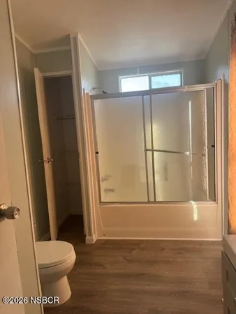 a bathroom with a shower a toilet and a bathtub