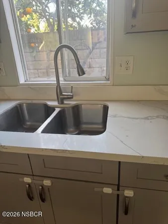 a kitchen with granite countertop a stove and a cabinets