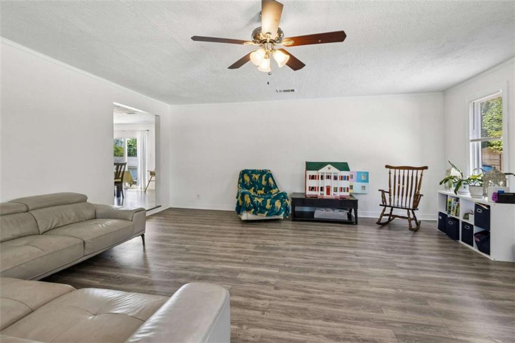 795 Tanner Road Dacula, GA 30019 - Photo 11 of 47 a living room with furniture and wooden floor