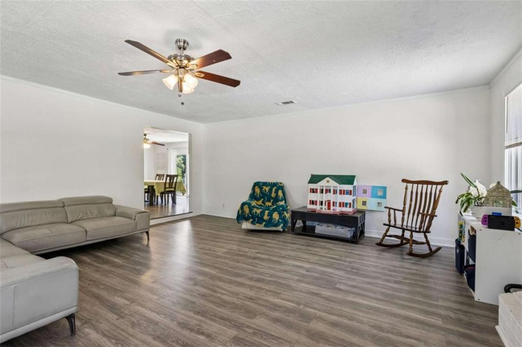 795 Tanner Road Dacula, GA 30019 - Photo 12 of 47 a living room with furniture and a wooden floor